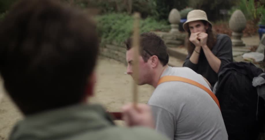 Three street performers playing their instruments together