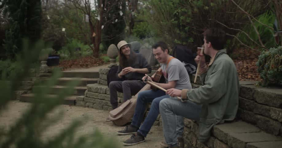 Three street performers playing their instruments