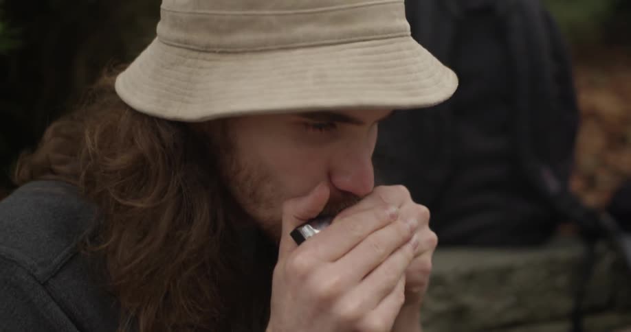 A man is playing a harmonica