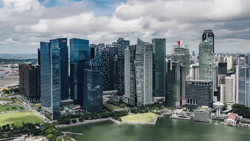 Clouds travel over skyscrapers on a waterfront in a metropolis during the day