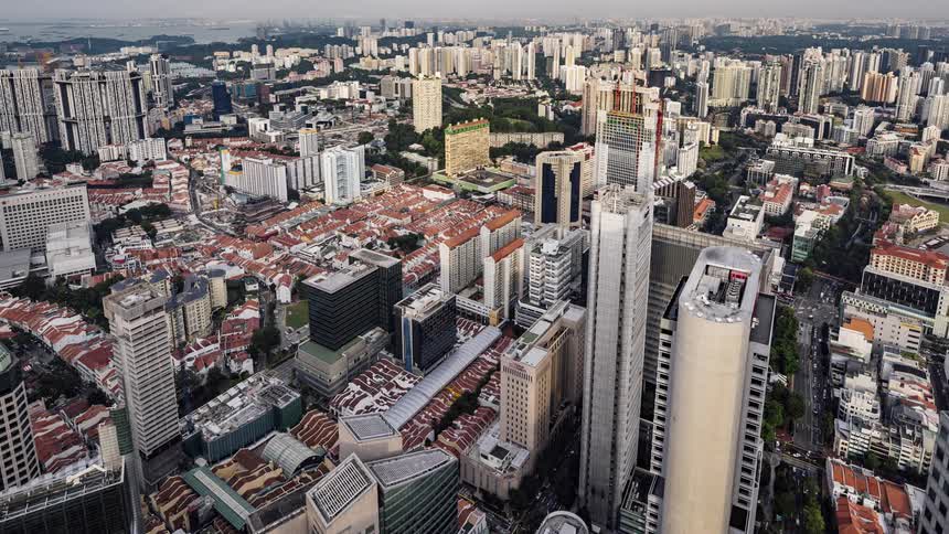 Traffic passes through dense city streets