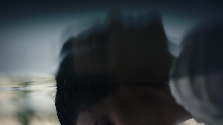 The reflection of a womans face in water
