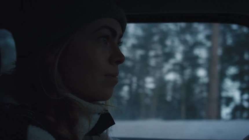 A woman is driving in the winter