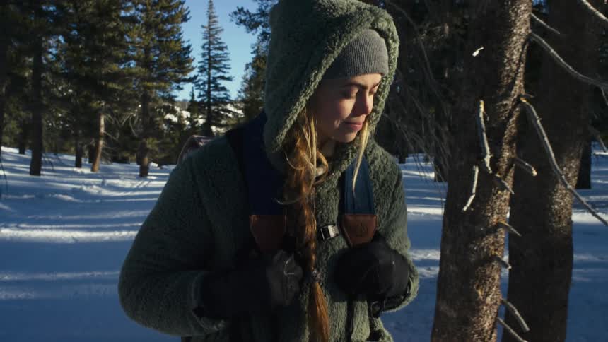 A woman is walking through the forest