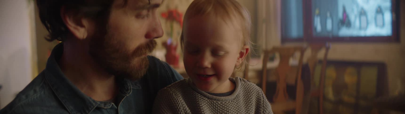 A baby sits in his fathers lap