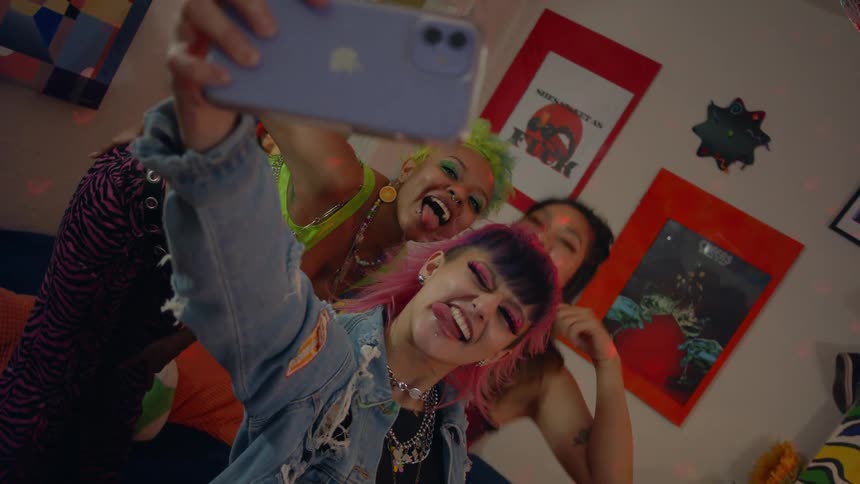 Three friends dance and take a selfie
