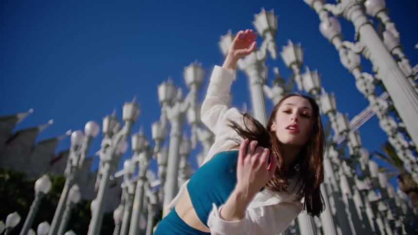 A woman is dancing outside