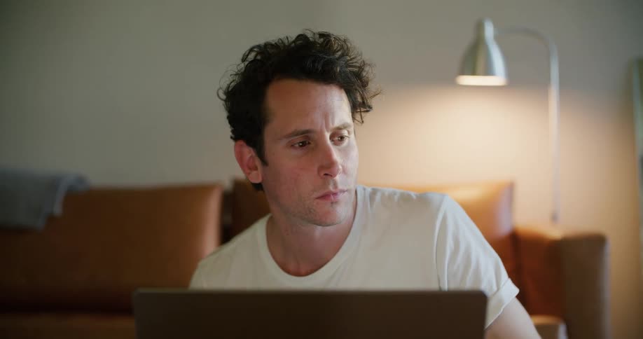 A man using a laptop in a room