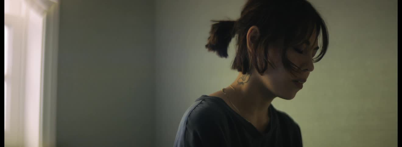 Sad woman sitting on a room at home is hugged by her partner