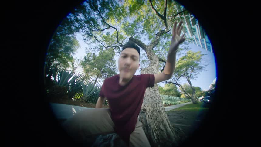 A man is dancing outdoors in the spring time
