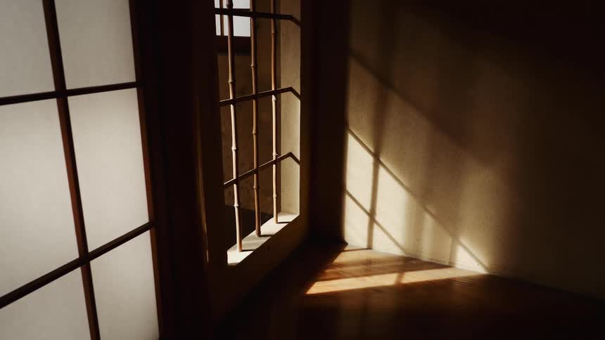 Shadow of a bamboo grate on a window inside a dimly lit room