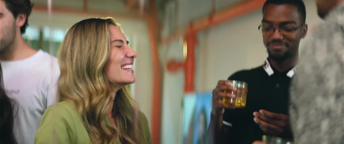 Blonde woman laughing with friends at a party
