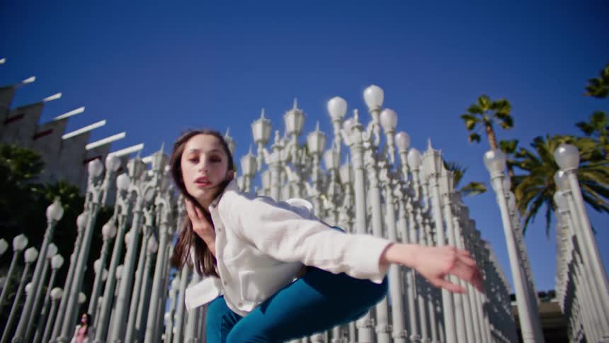 A woman is dancing outside
