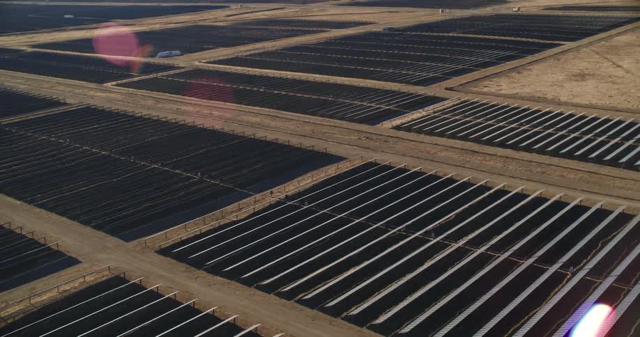 Aerial view of solar panels on a solar farm covering the ground in the desert