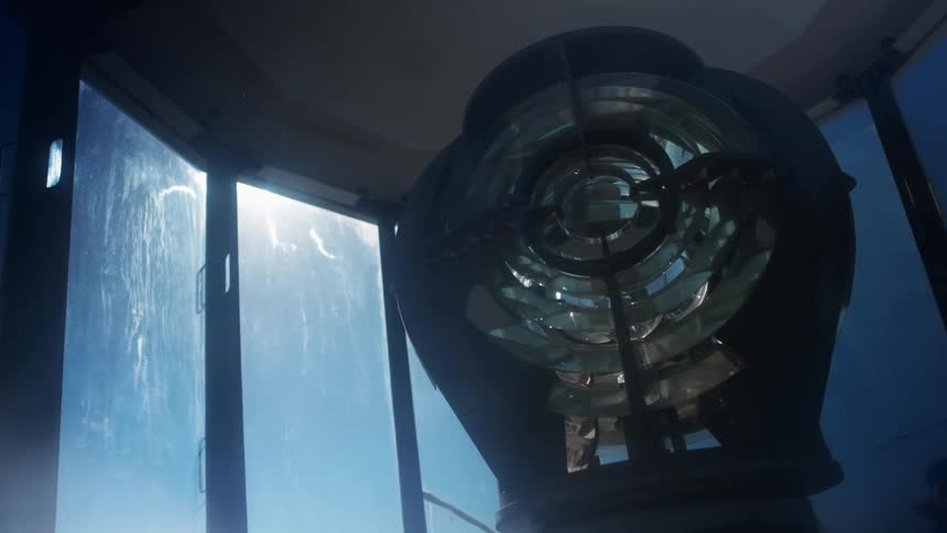 A lamp spins around in the lantern of a lighthouse