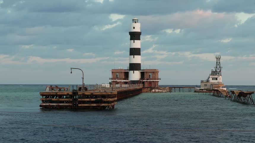 The lighthouse is on the pier