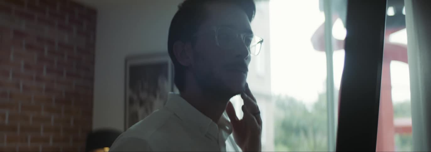 A man standing around in a room thinking