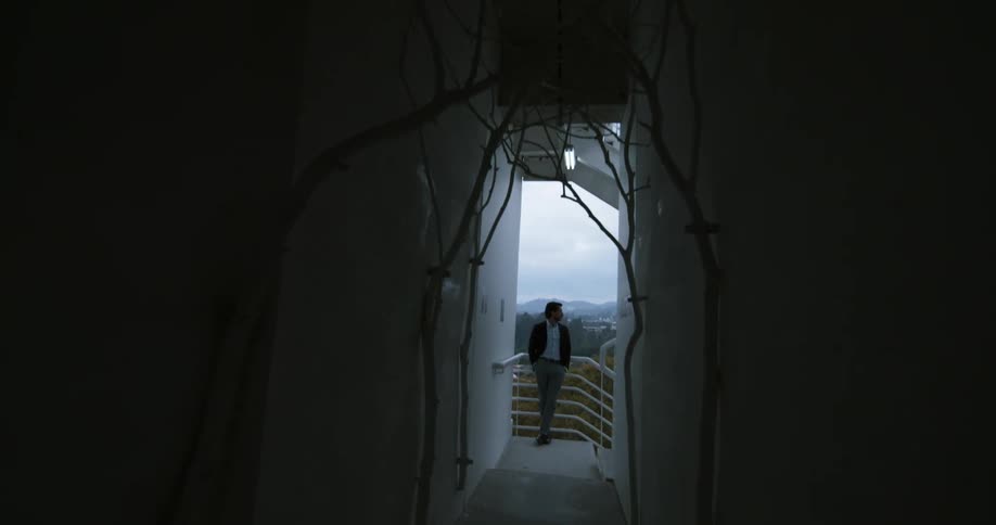 A man leans against the railing