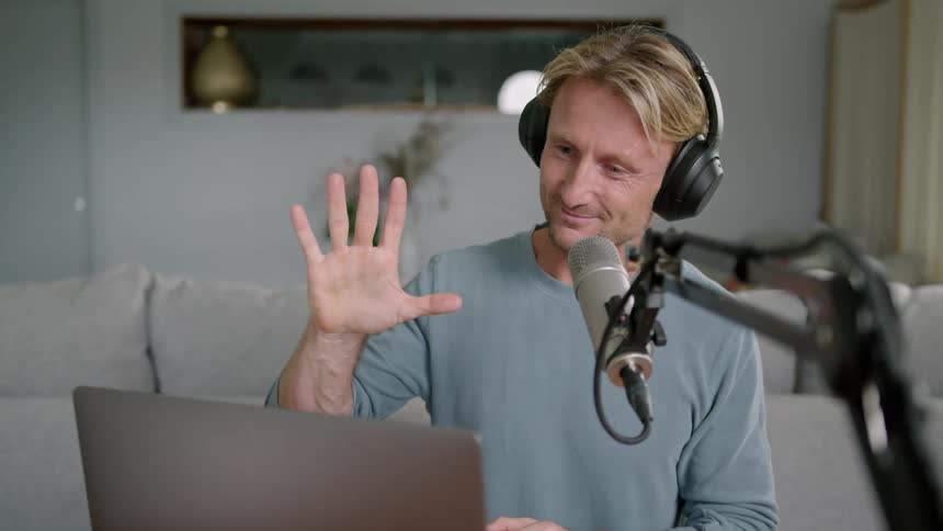A man greets someone talking on the computer