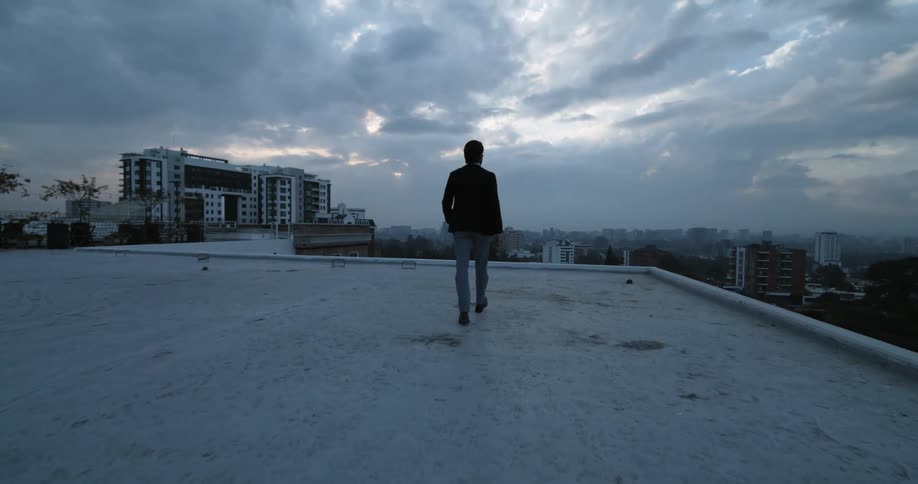 A man is walking on the rooftop