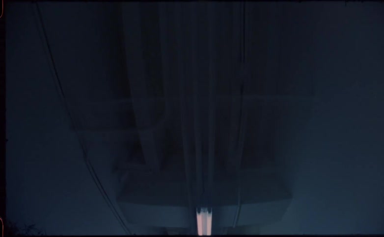 Flashing fluorescent lights on the ceiling of a dark subterranean hallway