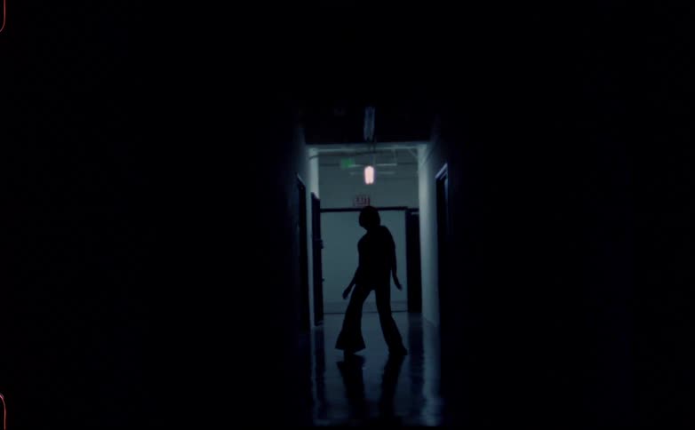A woman dancing in a hallway