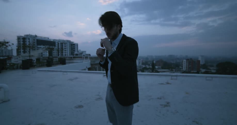 A man throws some punches on the roof
