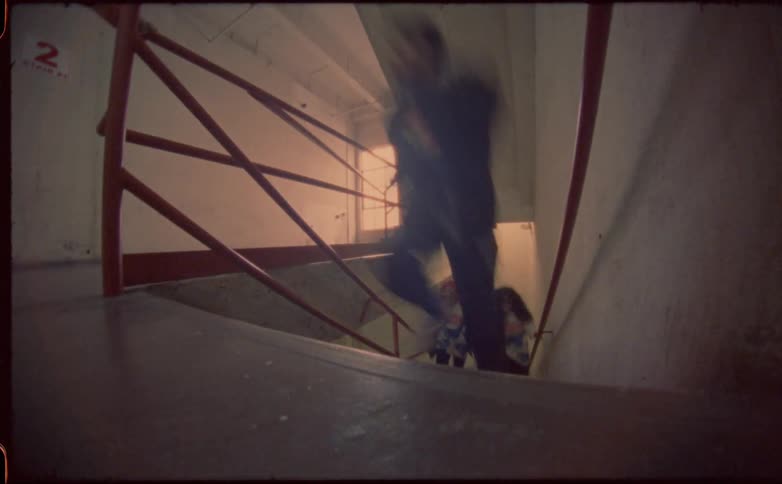 Students laugh as they run up the stairs in school