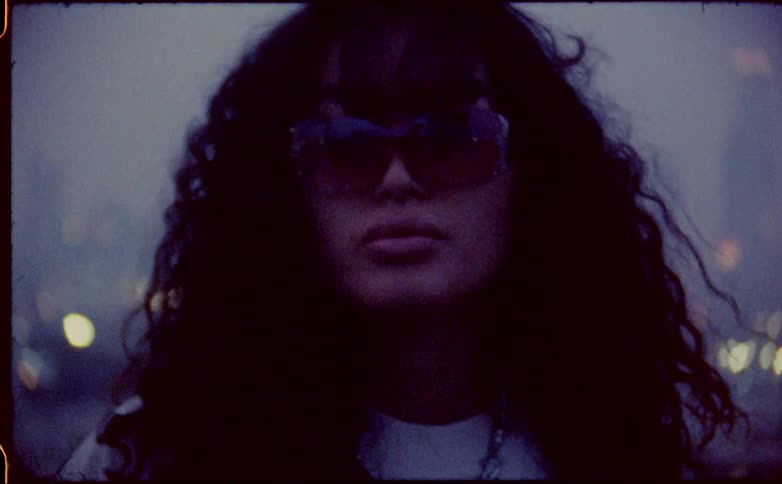 A woman is wearing large sunglasses