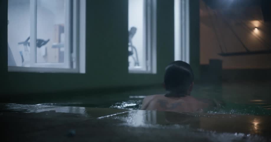 A man swims alone at a gym pool