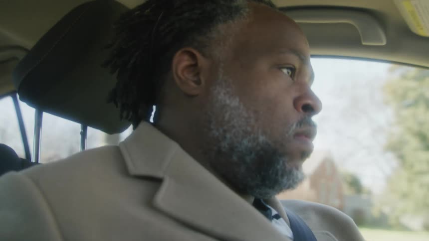 A man driving a car down a road