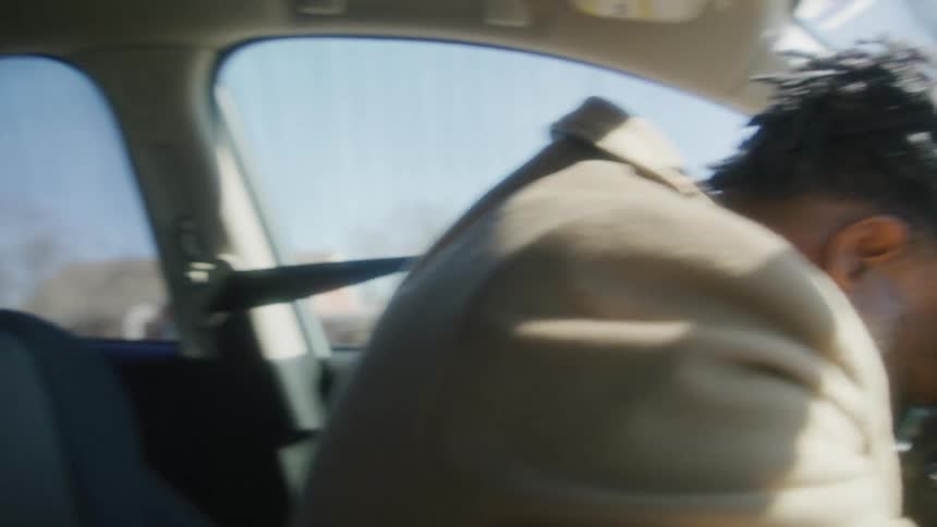 A man hitting his head against a steering wheel