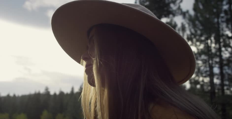 A woman walks outside by the lake