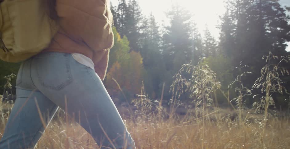 A woman hikes through the tall grass