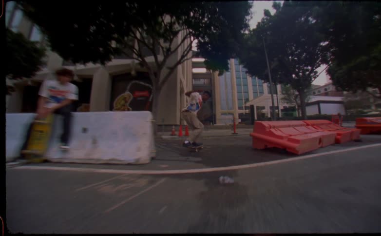 Young man jumping on the city streets with a skateboard caught on vintage film