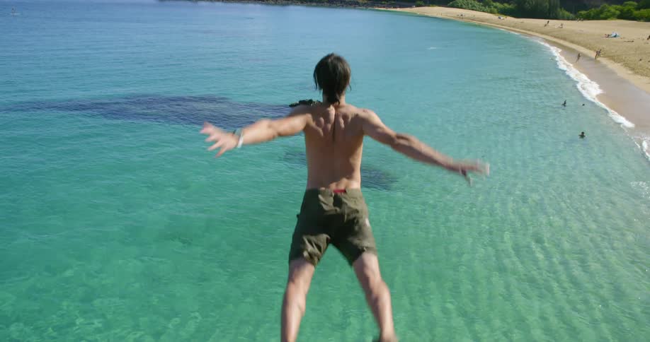 A man jumps into the ocean