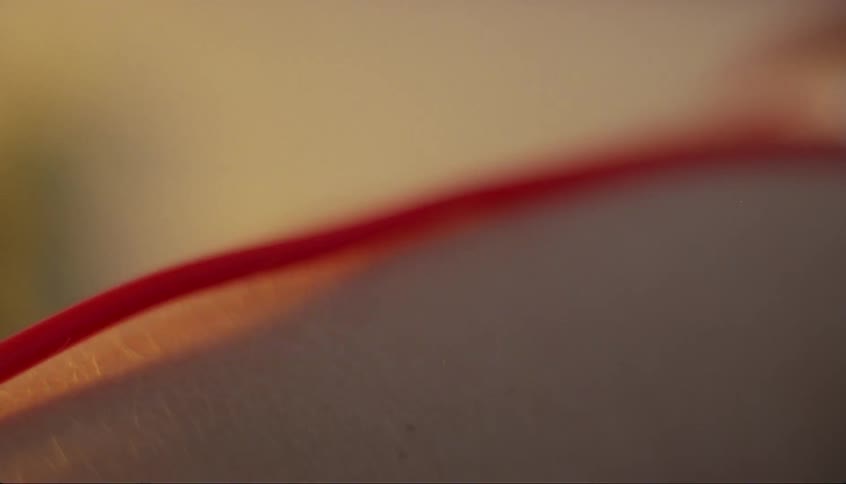 Blood runs through an intravenous tube attached to a hospital patient