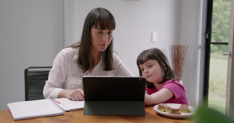 A mother and daughter using a tablet