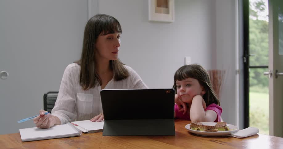 A mother and daughter looking at a tablet