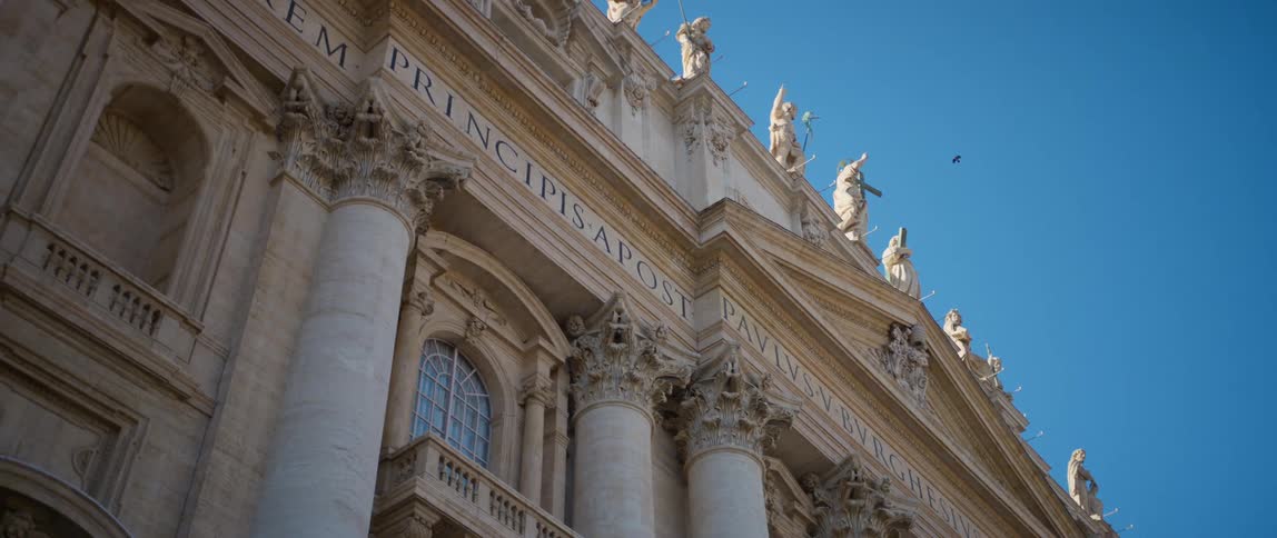 Apostles on the facade of st peters basilica against the blue sky