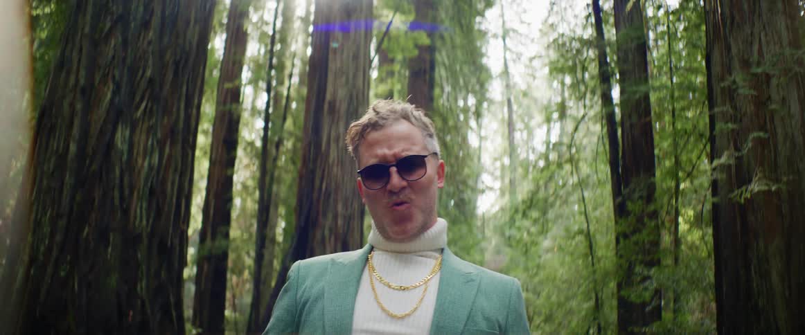 A man is posing in the forest
