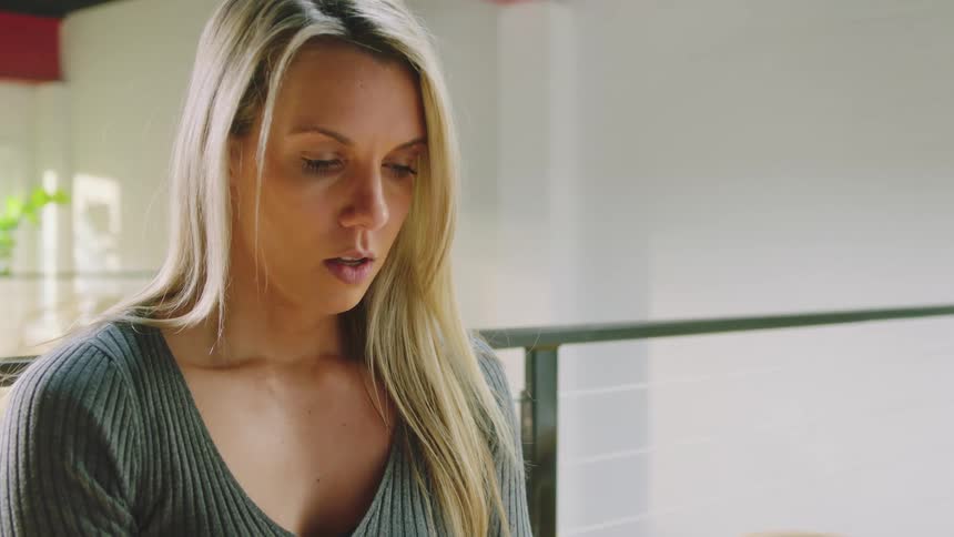 A woman is breaking and looking down