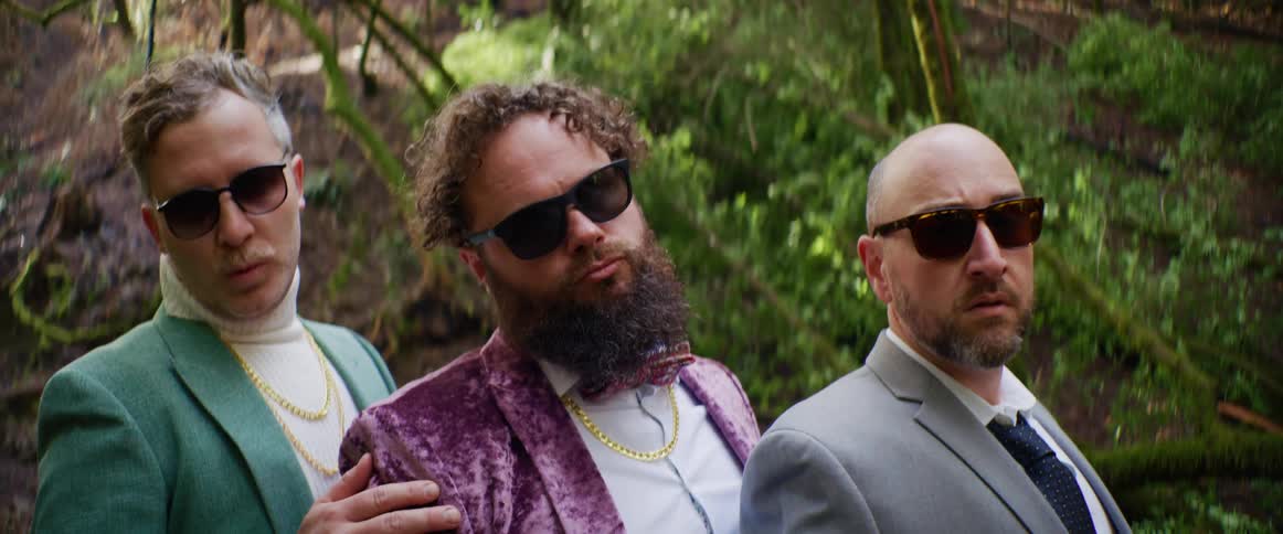 A portrait of three men outdoors