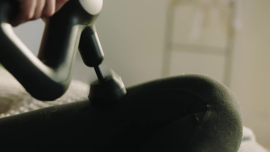 A person using a massage gun
