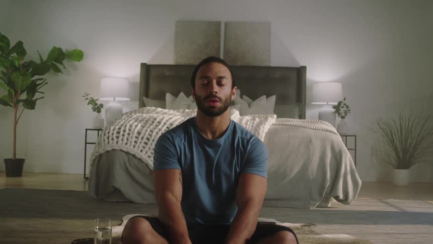 A man meditating on the floor
