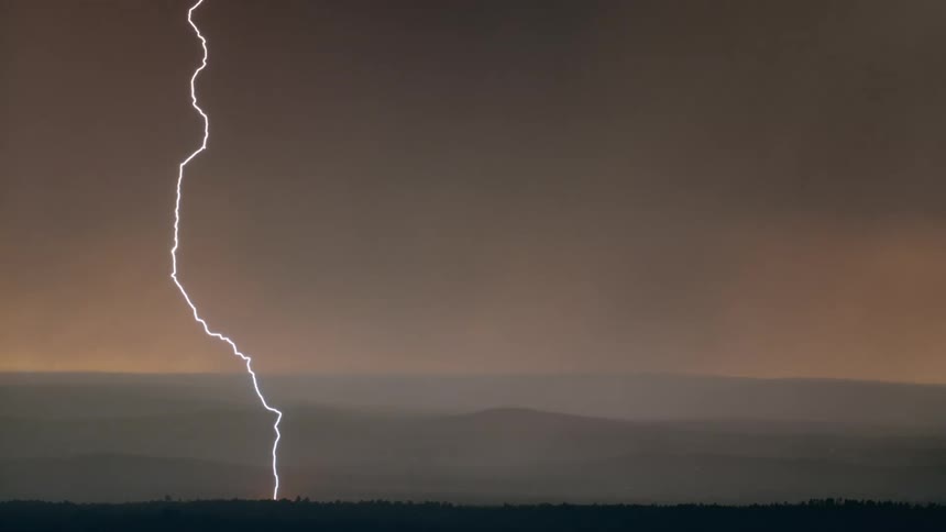 A thunderstorm is happening outdoors at dusk