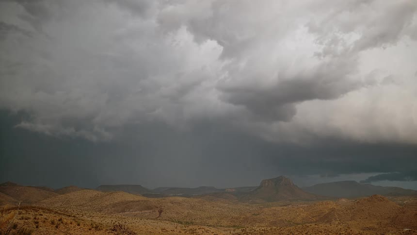 Lightning strikes and flashes over a canyon