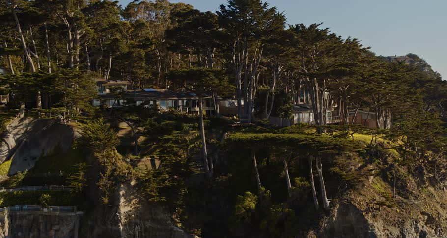 Aerial view of mountains near the coast of water is displayed