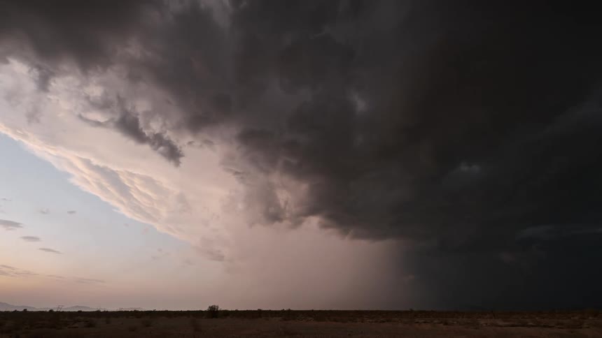 On the horizon dark gray storm clouds are gathering with lightning