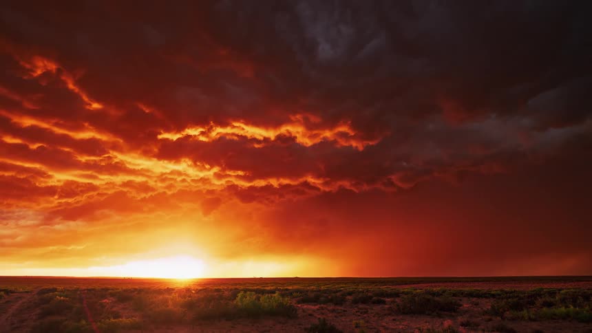 Storm clouds moving over the land as the sun sets